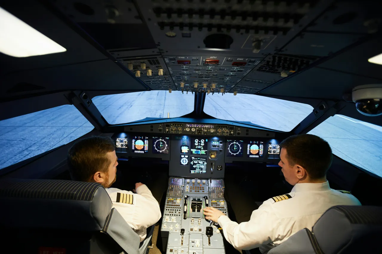 Two men inside the cockpit of an airplane