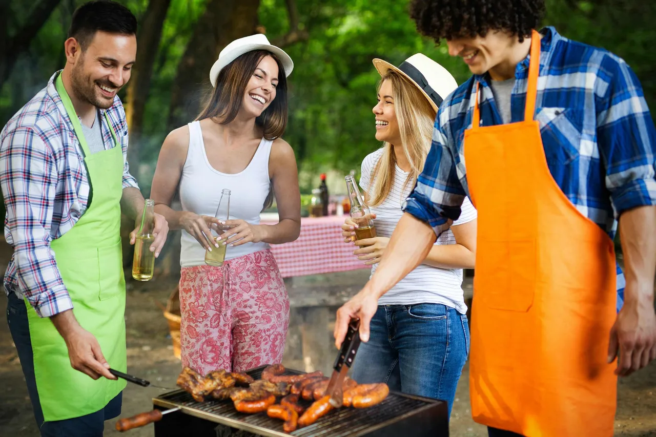 A group of people standing at a bbq