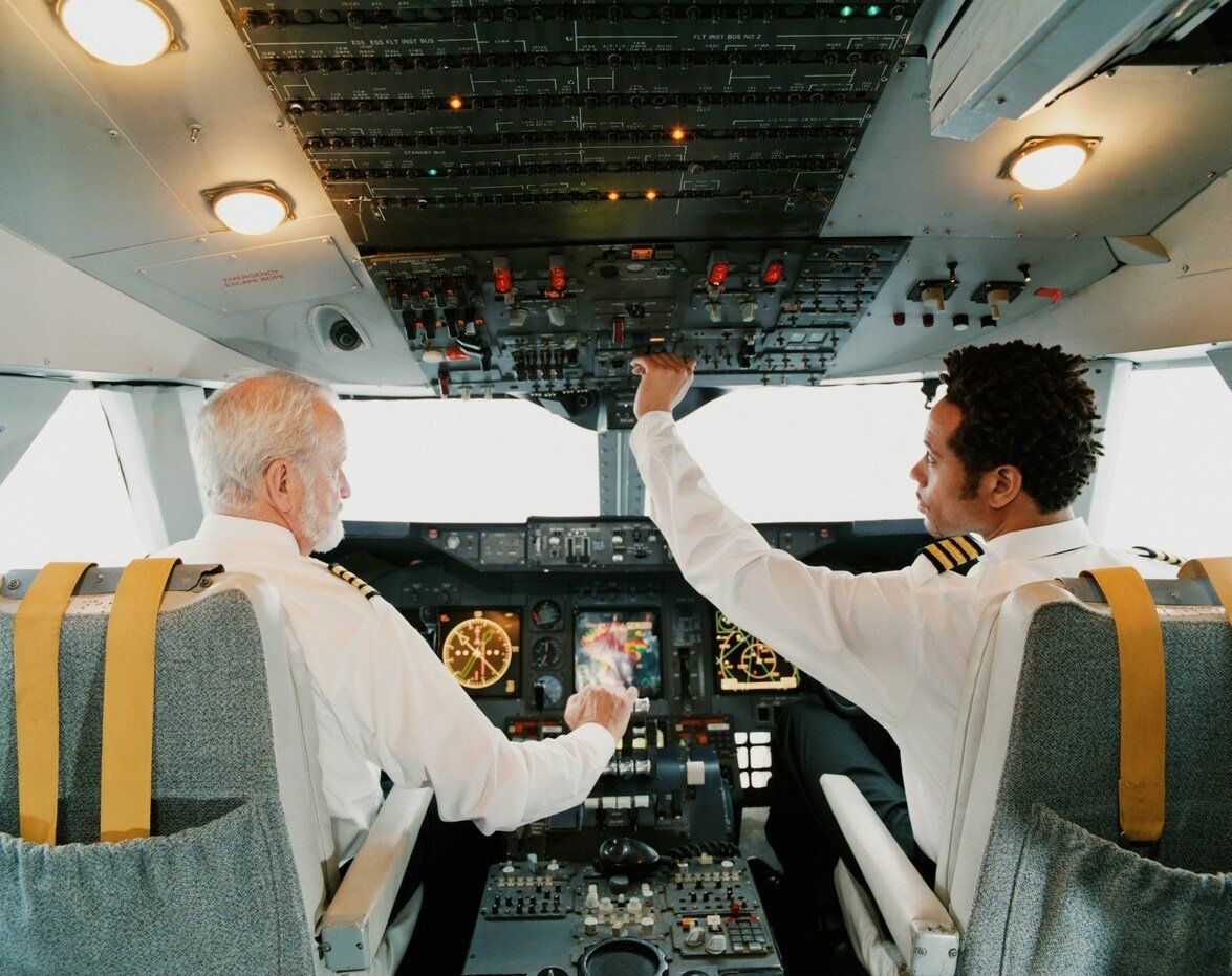 Two people sitting inside an airplane