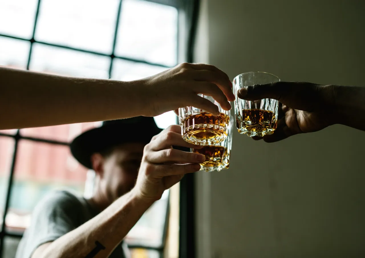 Three friends clinking glasses together