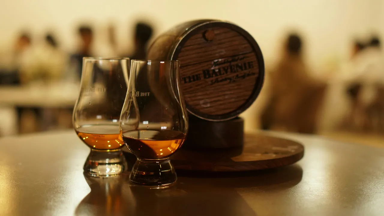 Two glasses in front of a barrel