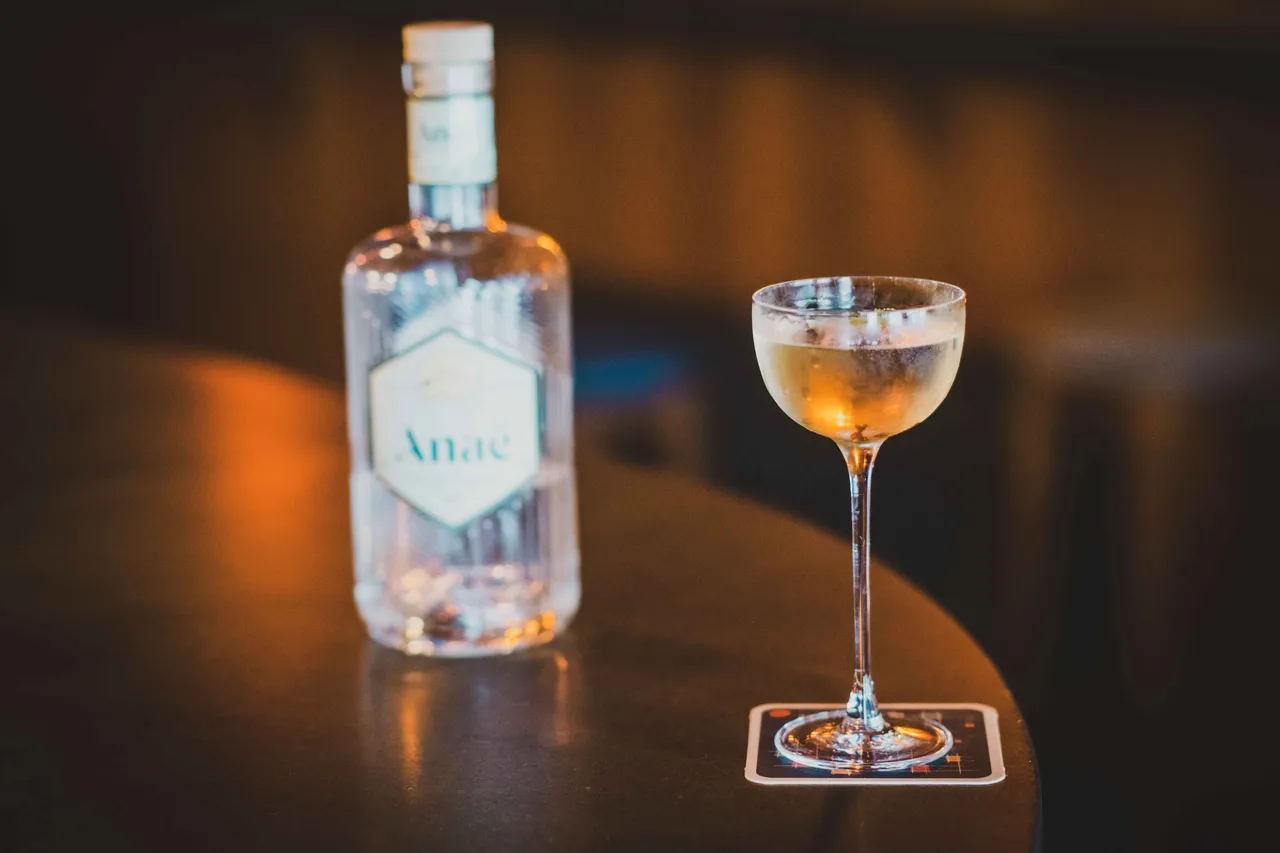 A bottle of Anae gin next to a glas