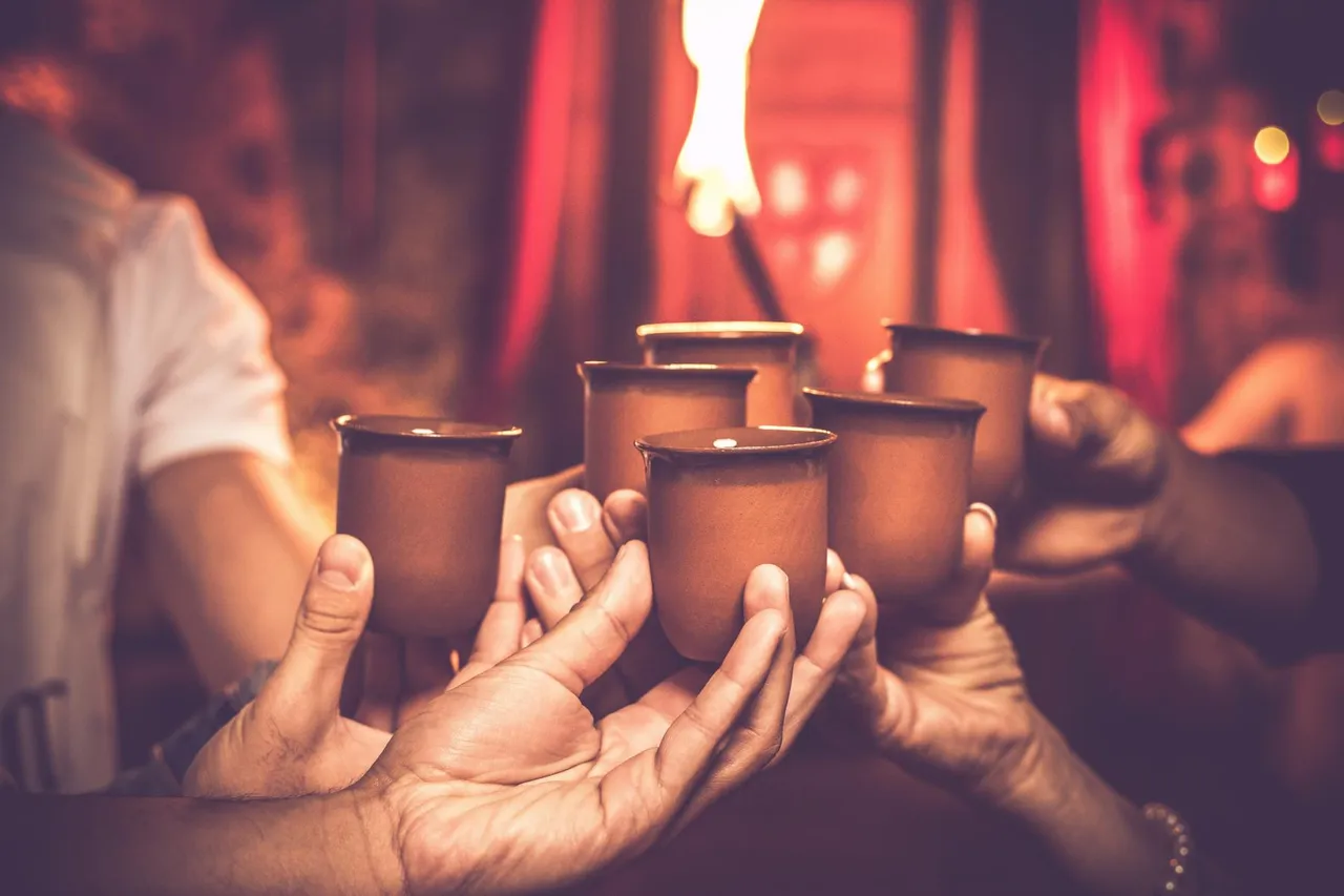 Guests toasting with clay cups