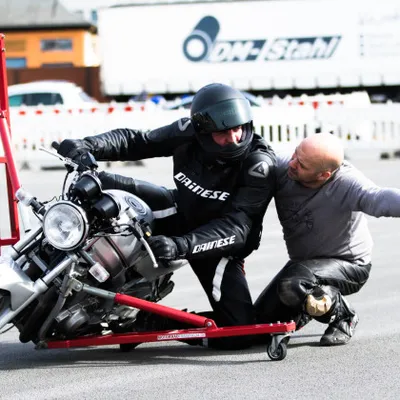 A person explaining how to use hang-off skills on a motorbike