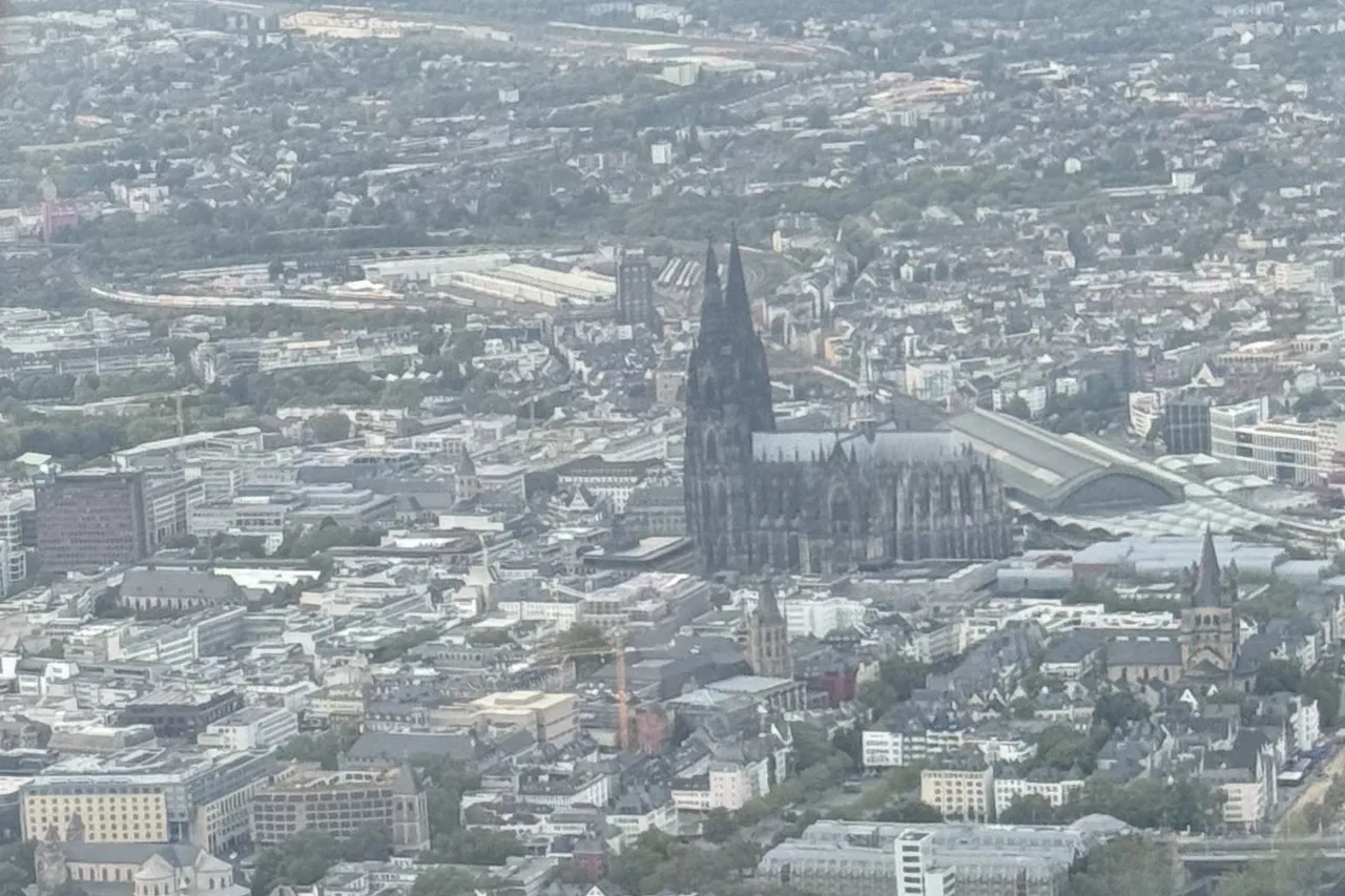 Aerial view of Cologne Cathedral, the old town and the Rhine from a helicopter