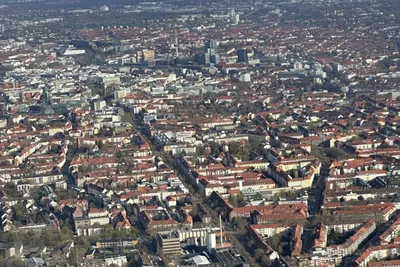 Aerial view over the rooftops and green parks of Hanover from a helicopter
