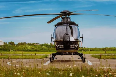 Front view of a helicopter standing on a grass airfield in summer