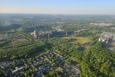Green Ruhr area landscape and city skyline seen from a helicopter on a sunny day