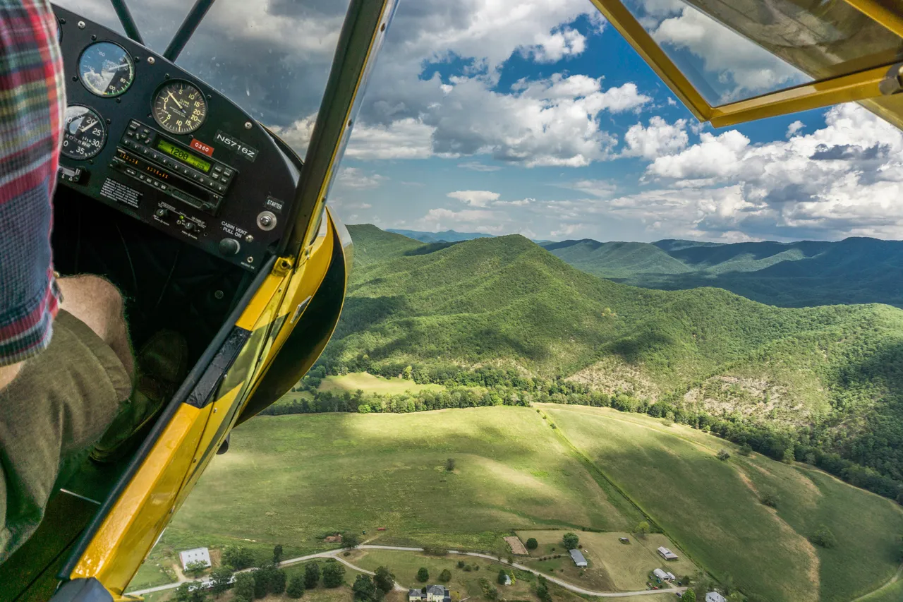 Flying in a helicopter over a green landscape