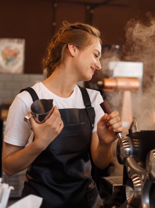 Woman preparing coffee on a machine