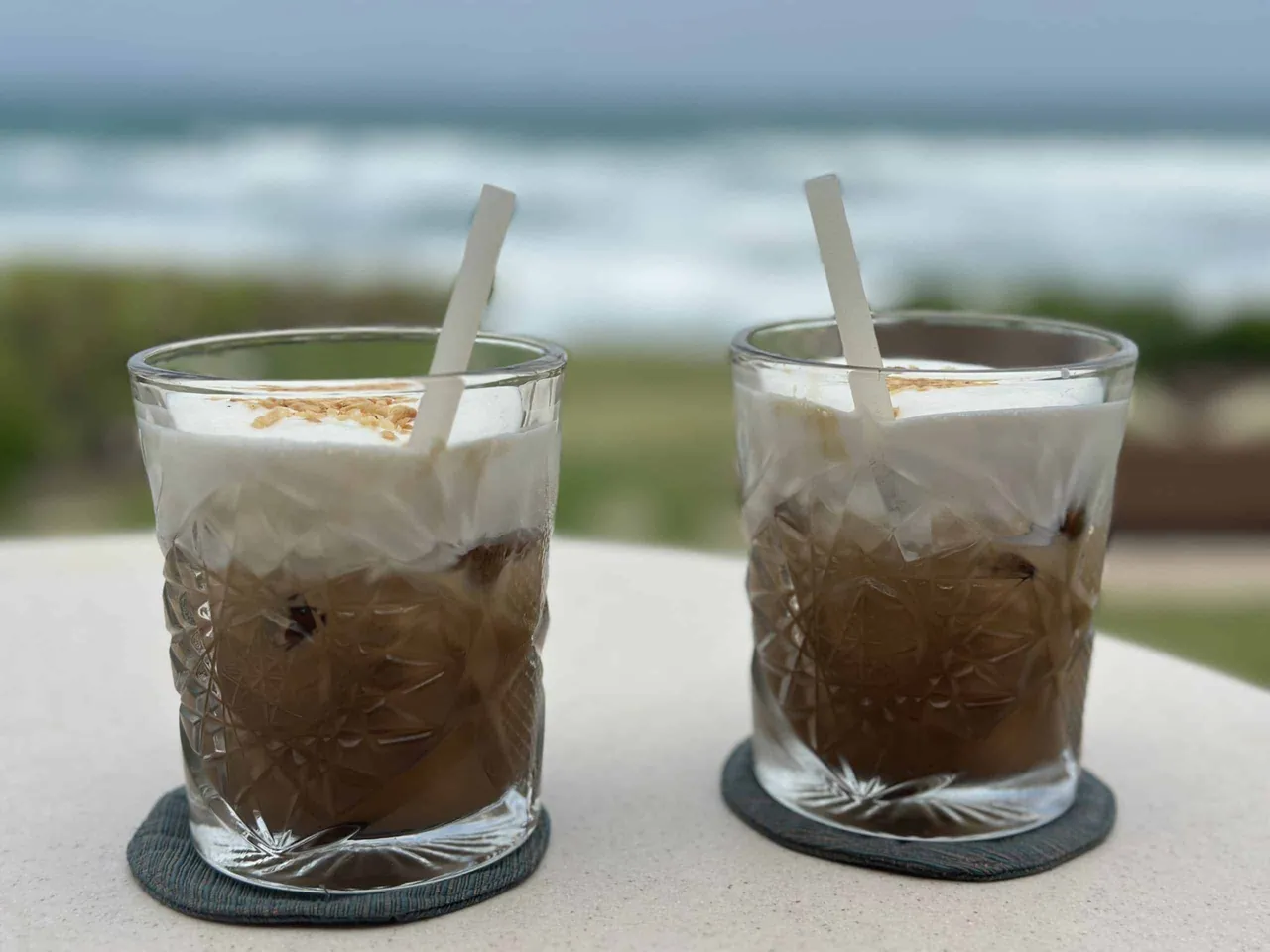 Two drinks with coffee on a table