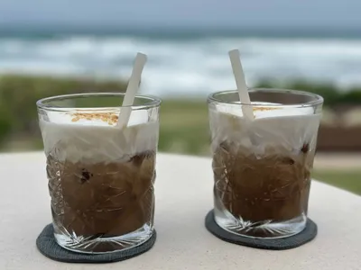 Two drinks with coffee on a table