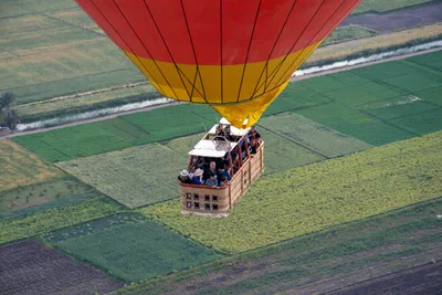 A hot air balloon flying over a landscape