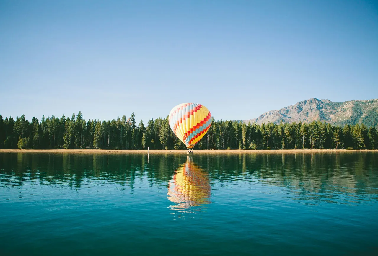 Colourful hot air balloon over a lake