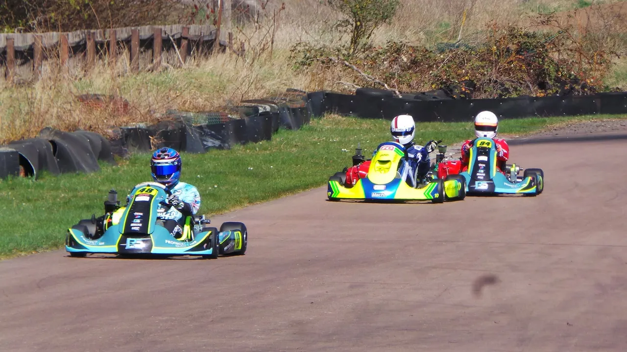 Three people in go-karts