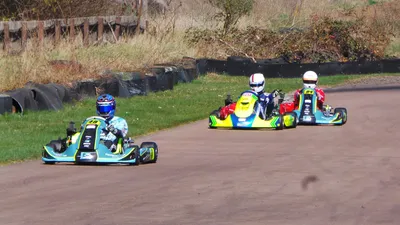 Three people in go-karts