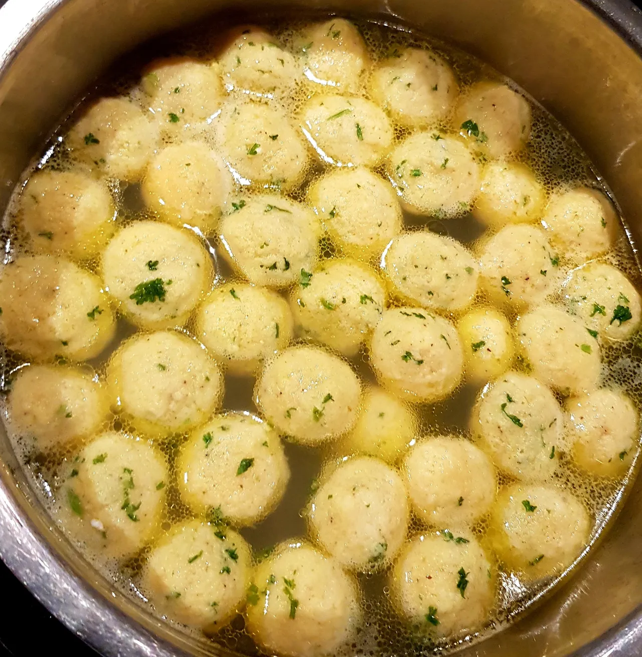 Dumplings cooking in a hot broth