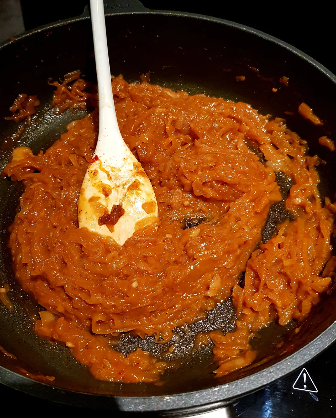 Onion sauce simmering in a frying pan