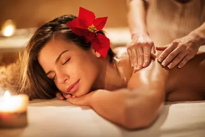 Woman receiving a soothing back massage in a luxury wellness spa.