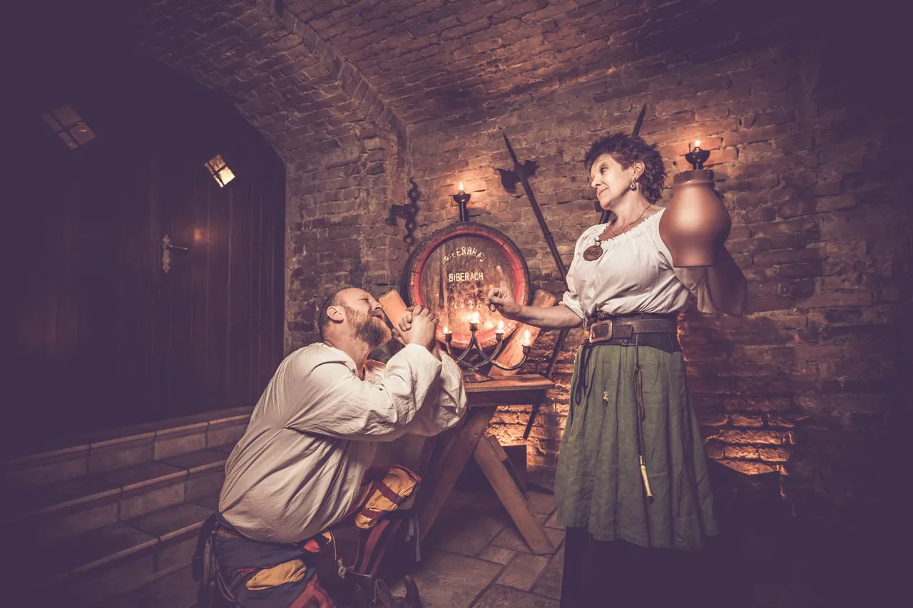 Maid in medieval dress serving a guest