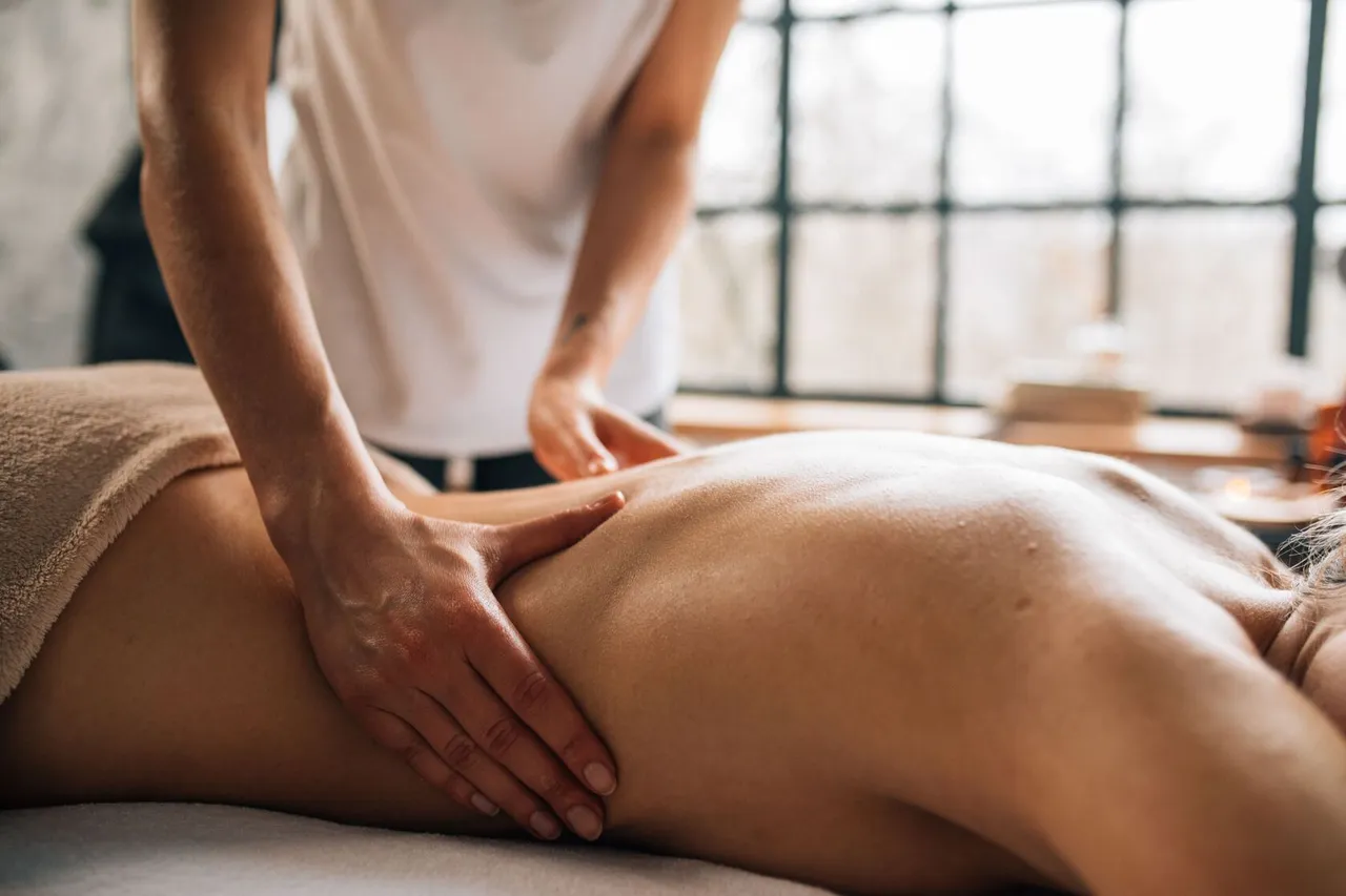 A person giving a back massage