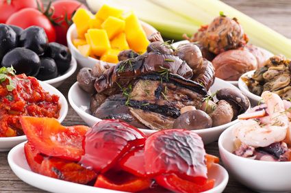 Bowls of Mediterranean antipasti with grilled peppers, aubergine, olives, mushrooms and seafood