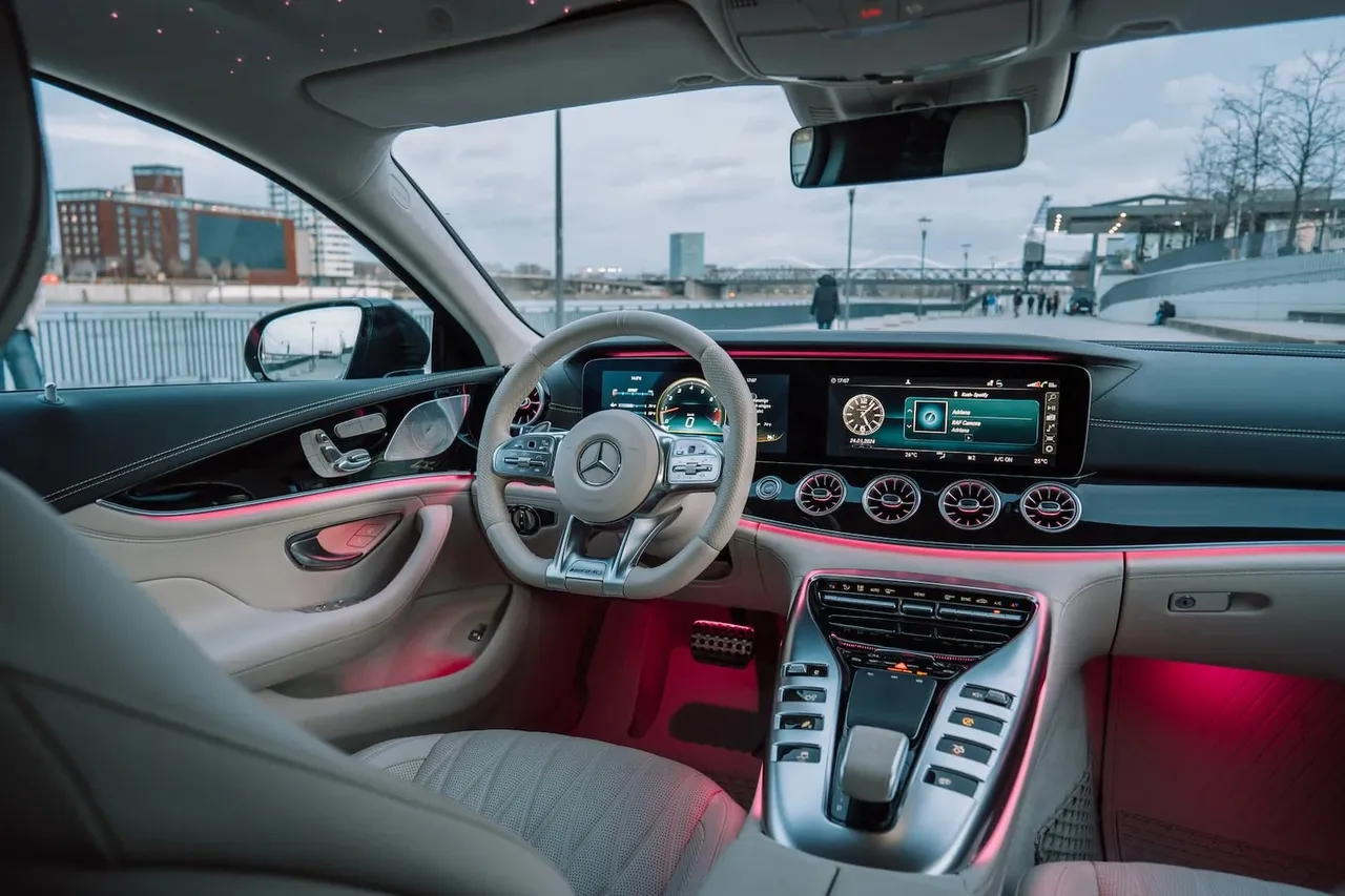Cockpit of the Mercedes-AMG GT 63 with widescreen display and red ambient lighting
