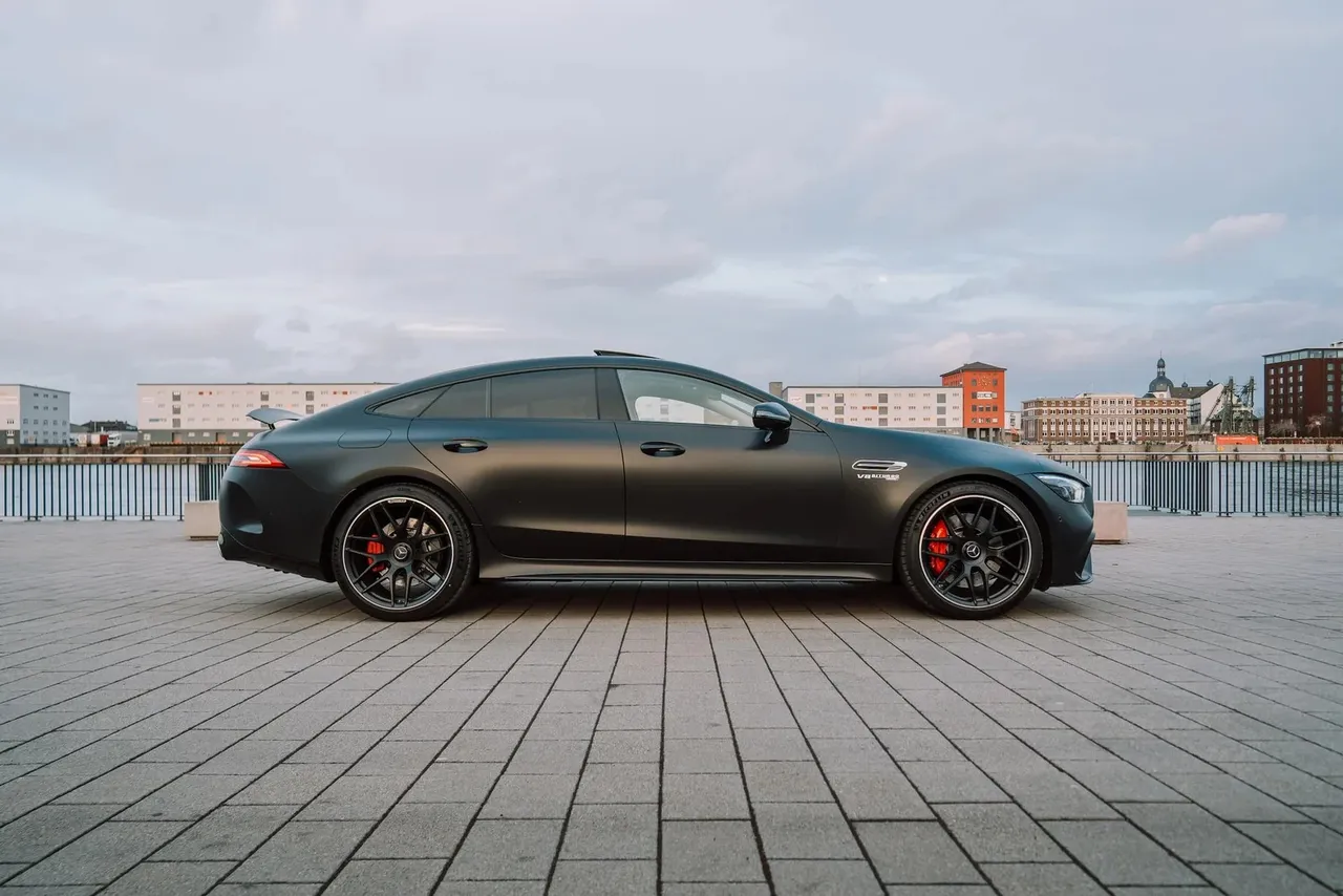 Side profile of a matte black Mercedes-AMG GT 63 with red brake calipers