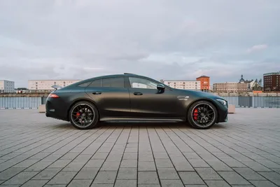 Side profile of a matte black Mercedes-AMG GT 63 with red brake calipers