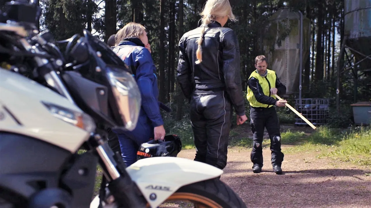 Person explaining a group about how to improve riding skills on a motorbike