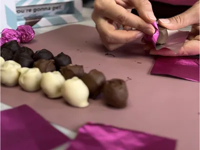 A person preparing chocolates