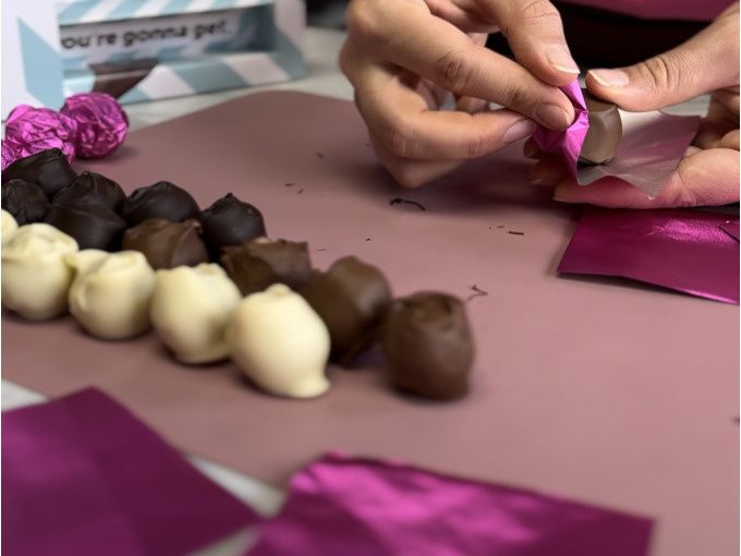 A person preparing chocolates