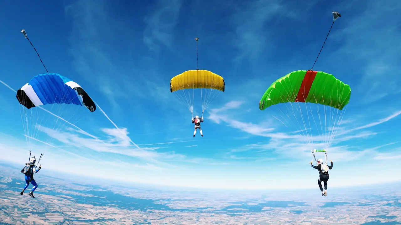 three paraglider flying over landscape