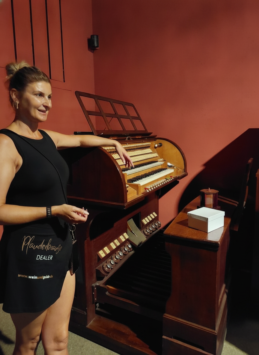 Woman in a black outfit explaining an old instrument