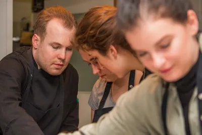 A group of people cooking together