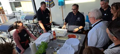 A cook explaining how to prepare the perfect pizza