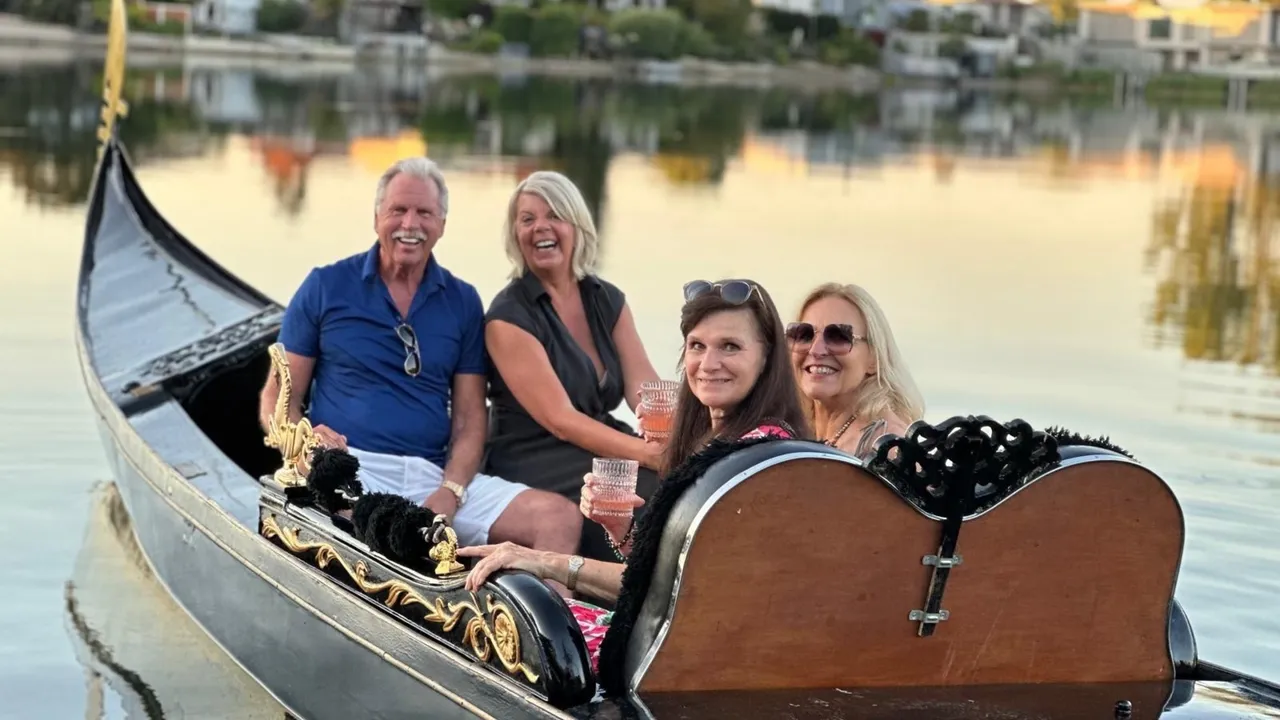 Smiling family of four enjoying a birthday gondola ride on the Havel in the evening sun