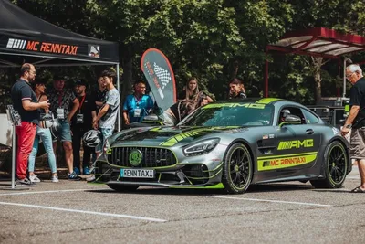 People standing around a racing car