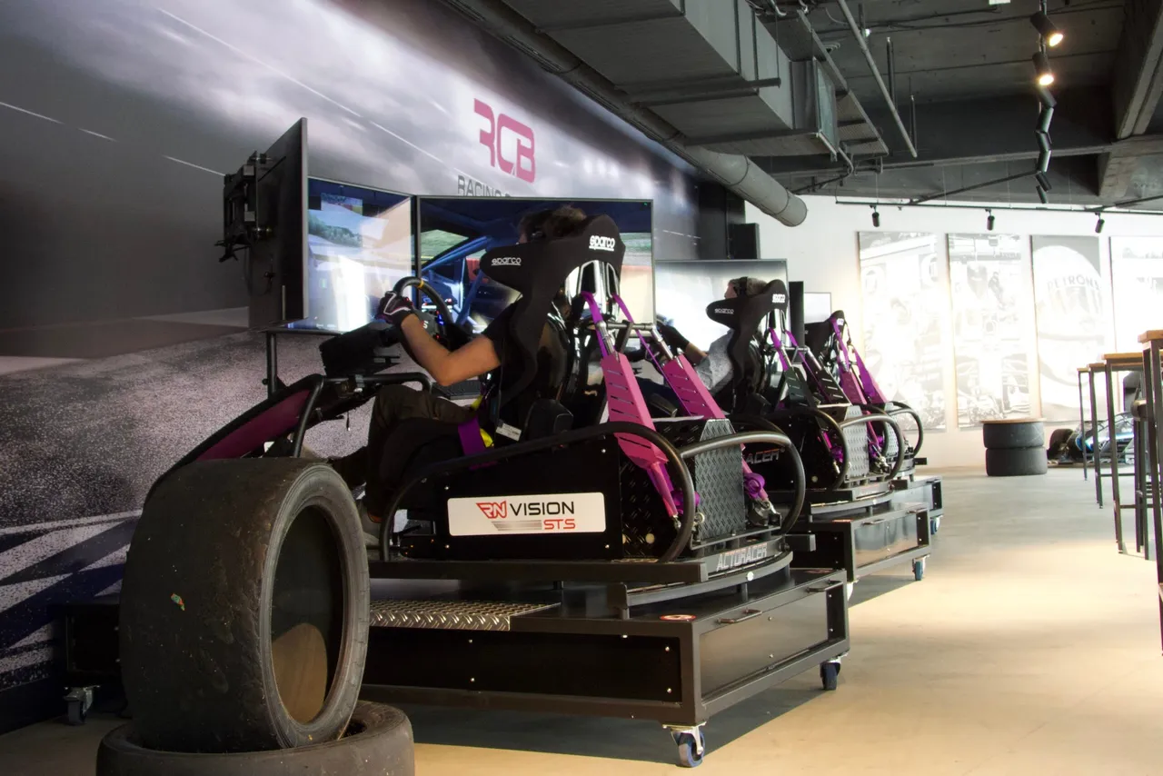 Drivers racing in a row of full-motion simulators