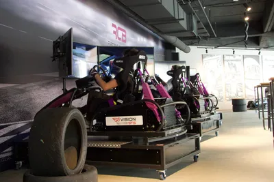 Drivers racing in a row of full-motion simulators