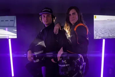 Two drivers in front of racing simulators at a group event