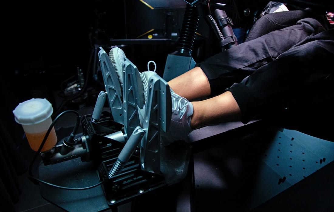 Feet operating a racing simulator