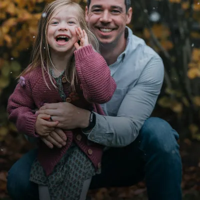 Gifts for dad: father giving his laughing little daughter a piggyback ride
