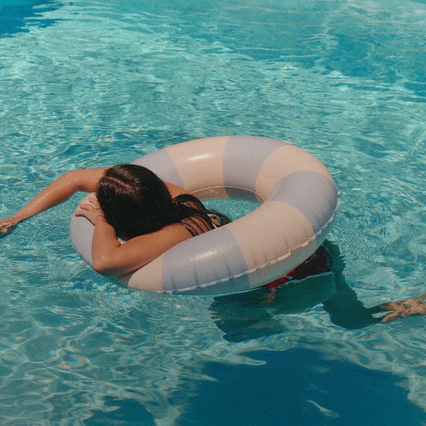 A woman in a swim ring in the pool