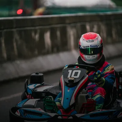 Gifts for men: driver in a racing helmet on a go-kart track