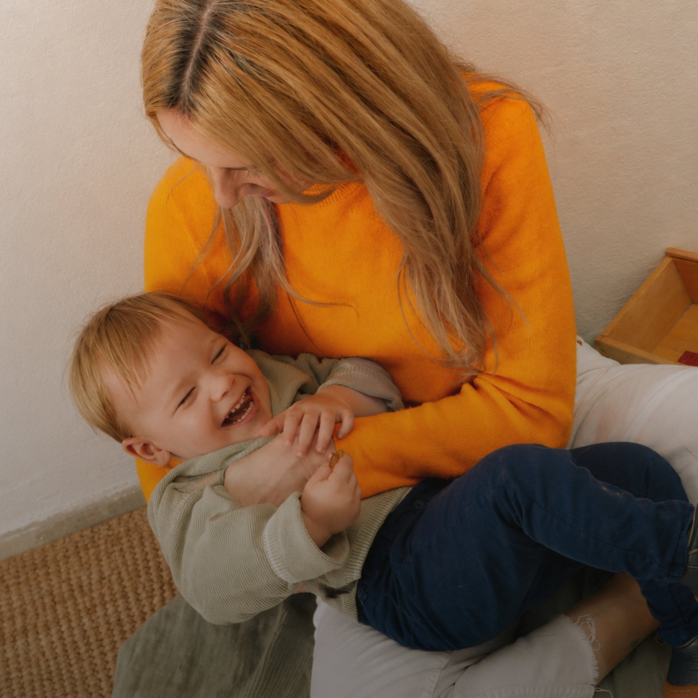 A mother laughing with her child