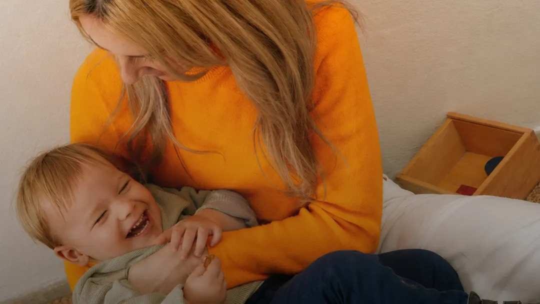 A mother laughing with her child
