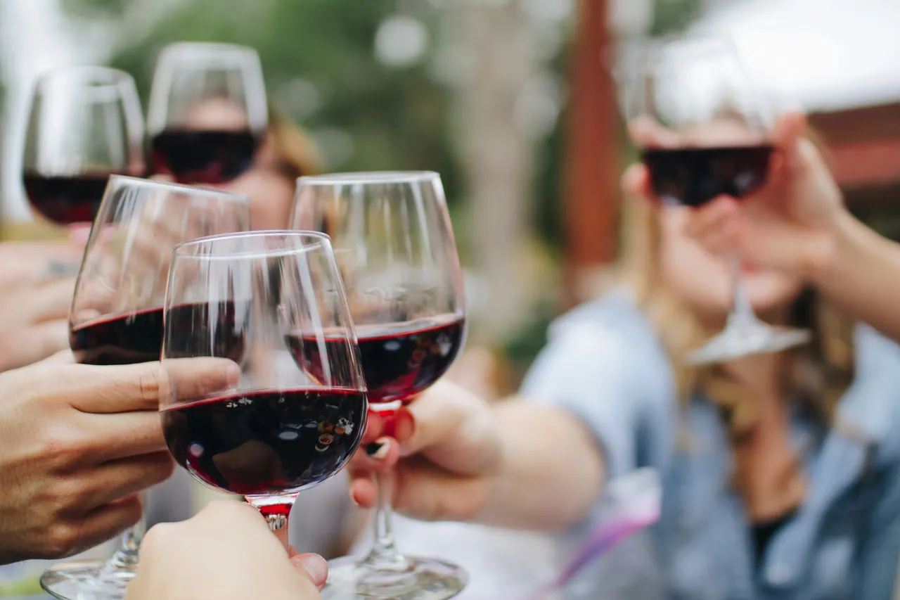 Wine glasses clinking together in a toast