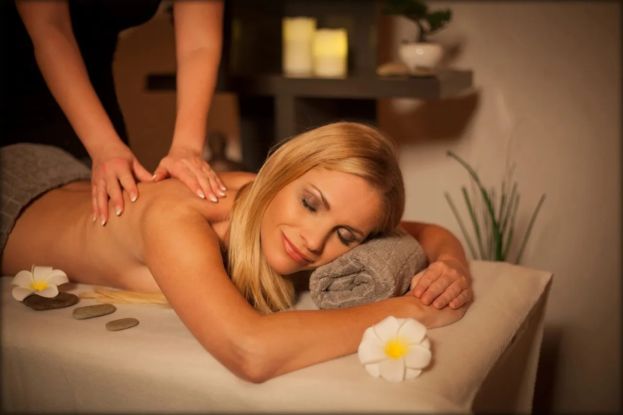 Woman enjoying a relaxing full-body massage treatment at a luxury spa.