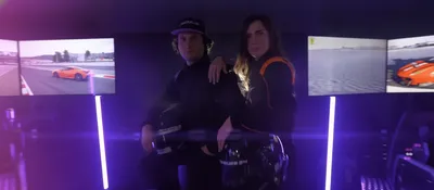 Two drivers in front of racing simulators at a group event
